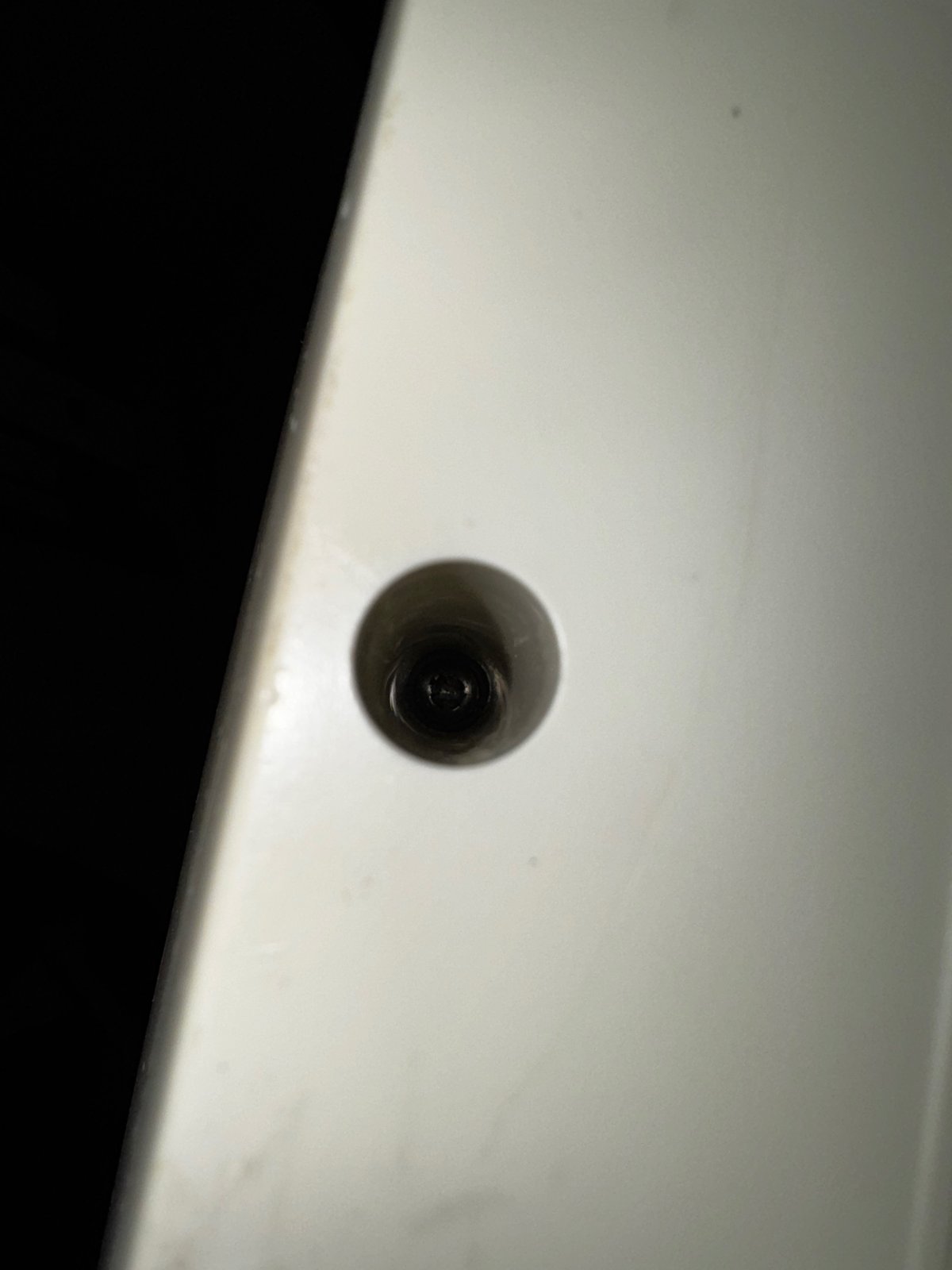 One of the deep screw holes of the case One of the deep screw holes of the case