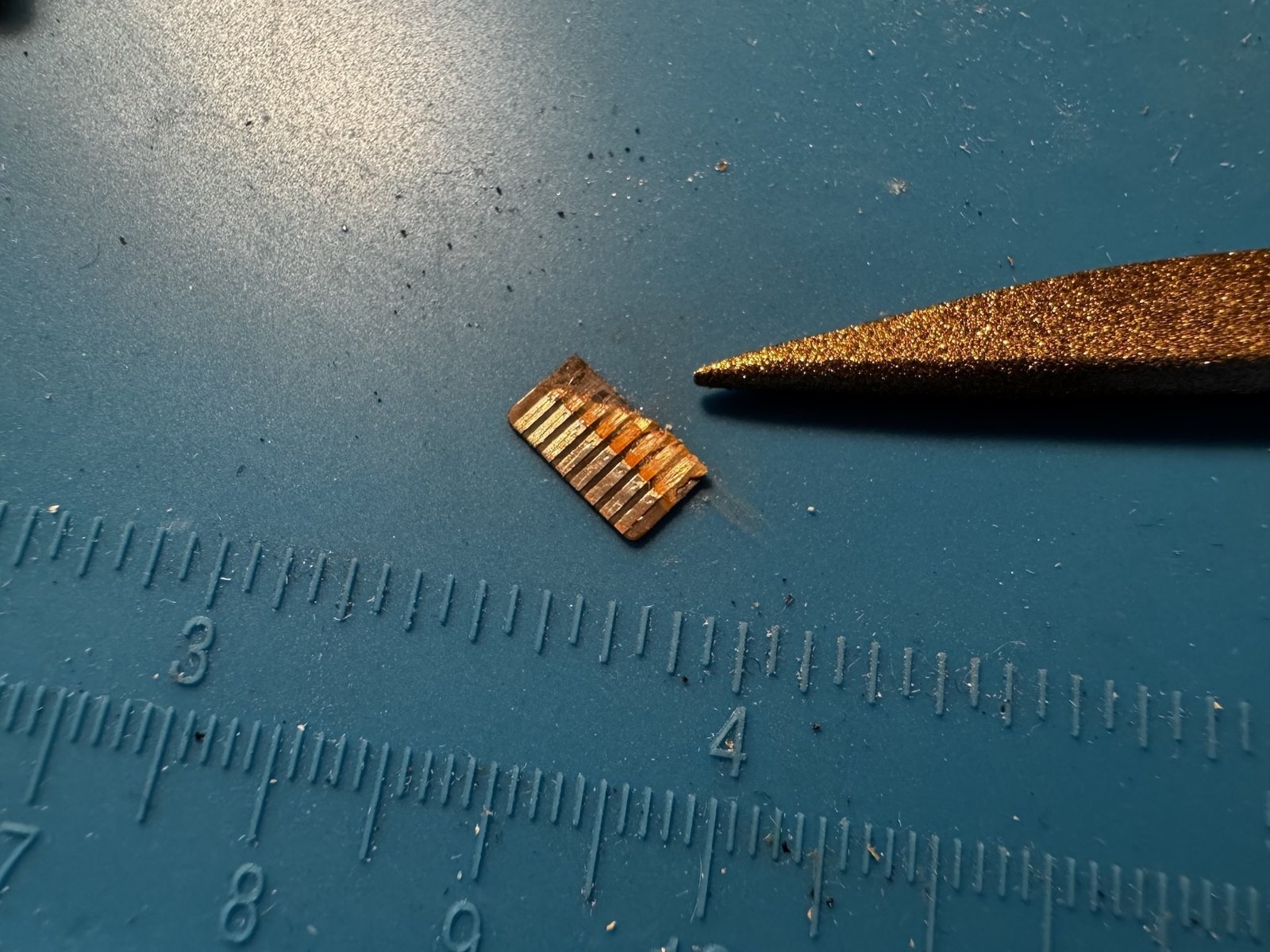 Scraping off the coating with a file