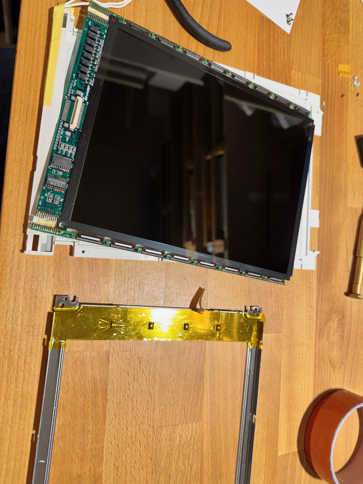 On the left the bare Sharp panel on the plastic frame of the Hitachi module, on the right the metal frame with Kapton tape On the left the bare Sharp panel on the plastic frame of the Hitachi module, on the right the metal frame with Kapton tape